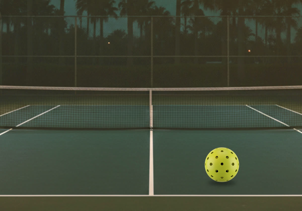 Pickleball on a court at golden hour